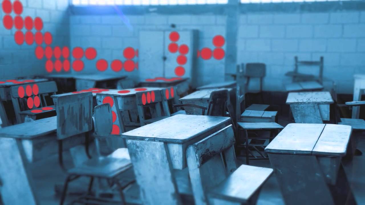 Video thumbnail of an empty classroom stylized with large red dots across the walls and some desks.