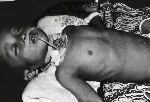 An Indonesian child with diphtheria laying on a bed with neck bandages, kept alive by a throat operation.