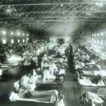 Inside an emergency hospital during 1918 influenza epidemic at Camp Funston, Kansas, showing rows and rows of bed.