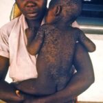 A man holding his child in his armes.