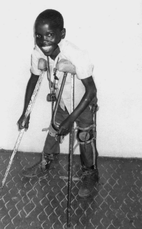 A young boy with polio using handmade braces, in Kenya.