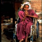 A young woman with polio in a wheelchair.