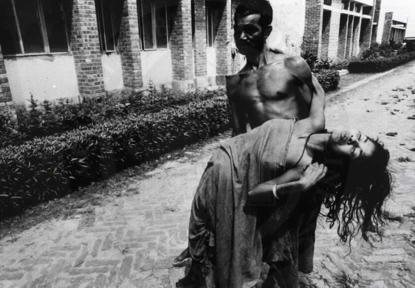 A frightened farmer carries his wife, stricken with tetanus, to the People's Health Centre in Savar, Bangladesh.